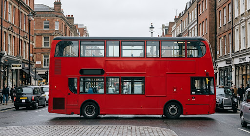 A red double-decker bus seen side-on in a London street